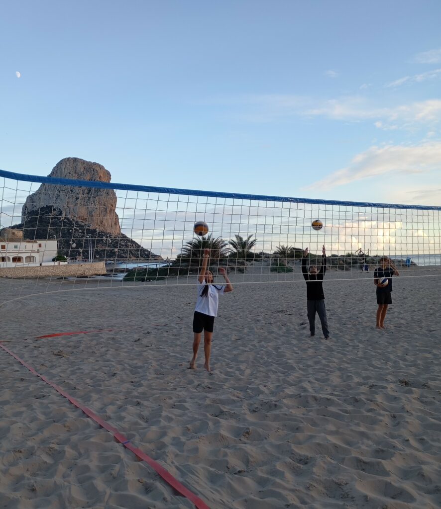 jugadores practicando vóley playa en Calpe con red y Peñón de Ifach